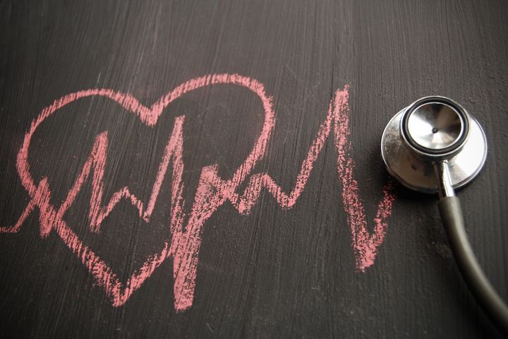 Stethoscope and heart shape on chalkboard
